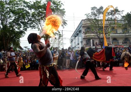 TARAKAN - INDONESIA, 25th July 2018 : attraction spray fire from mouth on march of archipelago culture - APEKSI 2018 in Tarakan City Stock Photo