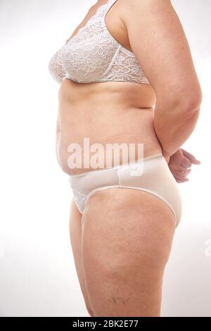 Photo of an Elderly Woman in Underwear on a White Isolated