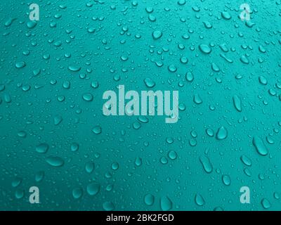 Drops of water on a turquoise metal surface, beautiful background after rain Stock Photo