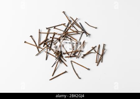 Rusty nails piling isolated on white background. Stock Photo