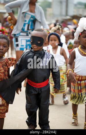abidjan, ivory coast - February 13, 2018: little boy dressed in zoro held by children also dressed in traditional clothes. Stock Photo