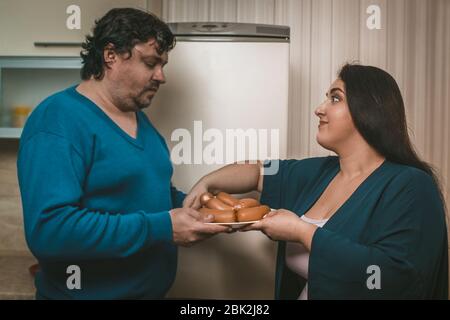 Hungry Body Positive Couple Holding Plate With Sausages Stock Photo