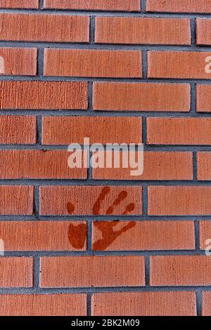 Wet melted palm print on frosty red tile wall at Winter , Finland Stock Photo
