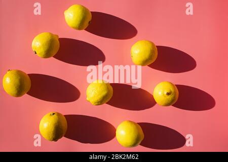 Flat lay composition with lemons on pink background, Stock Photo
