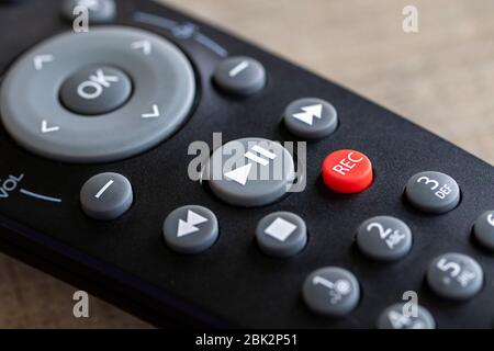 A close up portrait of a remote control to operate a surround sound system, television or other electronic device. The focus is on the play/pause, sto Stock Photo