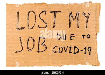 words lost my job due to covid-19 handwritten on rectangular flat sheet of cardboard - homeless placard, isolated on white background Stock Photo