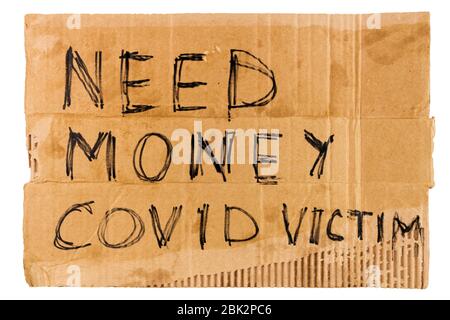 words need money covid victim handwritten on rectangular flat sheet of cardboard - homeless placard, isolated on white background Stock Photo