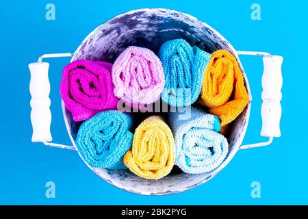 Bucket full of colorful towels. Detergent for different surfaces in kitchen, bathroom and other rooms. Closeup Stock Photo