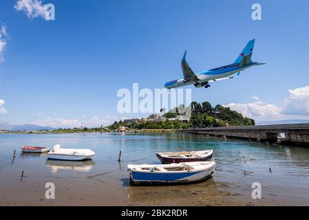 Thomson Boeing 767 aeroplane coming into land over the sea at Corfu International Airport. Stock Photo