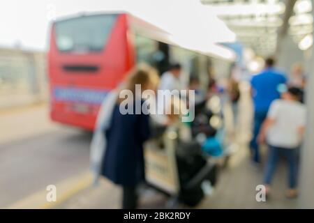 Defocused people in public transportation bus terminal at airport Stock Photo