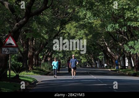 Johannesburg, South Africa. 1st May, 2020. Local people walk on the street in Johannesburg, South Africa, May 1, 2020. South Africa started easing lockdown restrictions from Friday. Credit: Chen Cheng/Xinhua/Alamy Live News Stock Photo