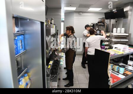 Members of staff pictured working in a McDonalds restaurant kitchen in the UK. Image is taken in the kitchen of a McDonalds restaurant. Stock Photo