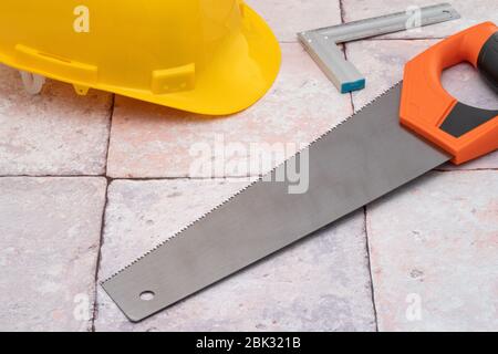 Carpenters work tools and yellow construction hat Stock Photo