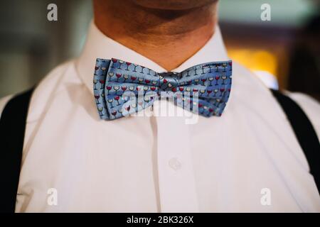 man in a blue bowtie getting ready Stock Photo