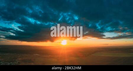 Aerial View Of Sunshine In Sunrise Bright Dramatic Sky. Scenic Colorful Sky At Dawn. Sunset Sky Above Autumn Field And Meadow, Forest Landscape In Eve Stock Photo
