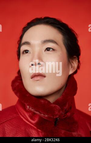 Asian man in red clothes on a red background Stock Photo