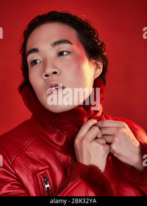 Asian man in red clothes on a red background Stock Photo