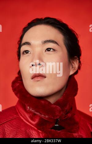 Asian man in red clothes on a red background Stock Photo