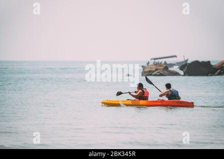 Anjadip, Goa, India - February 16, 2020: Two Men Floating In Arabian Sea Kayaking In Summer Sunny Day Stock Photo