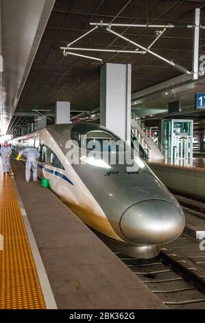 A Chinese CRH380A train being cleaned at Shanghai Hongqiao Station. China. Stock Photo