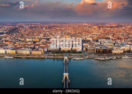 Budapest, Hungary - Beautiful golden clouds above downtown of Budapest at sunset taken from above. Szechenyi Chain Bridge, River Danube, St.Stephen's Stock Photo