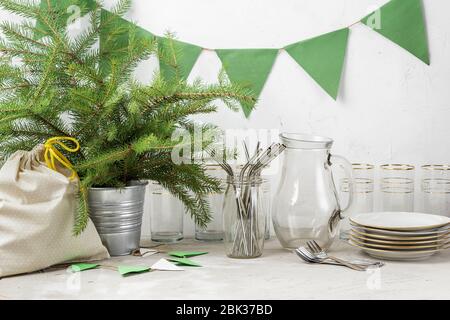 Reusable straws, drinking glass and plates paper flags, and gift in cloth bag prepared for eco friendly zero waste Christmas or New Year party with no Stock Photo
