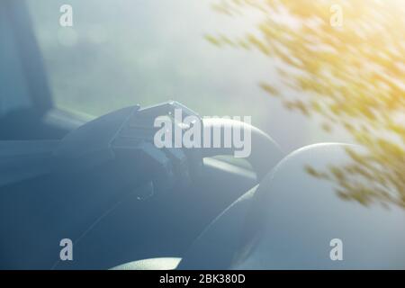 Robot arm on a steering wheel. Artificial intelligence drives a car. Autonomous vehicle concept. Stock Photo