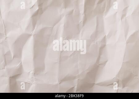 Crumpled paper texture, vintage background. Neutral beige wallpaper, wrinkled pattern surface. Decorative frame, creased blank sheet Stock Photo