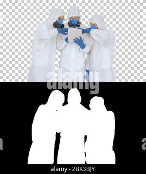 Doctors or scientists wearing hazmat suits working together on digital tablet, Alpha Channel Stock Photo