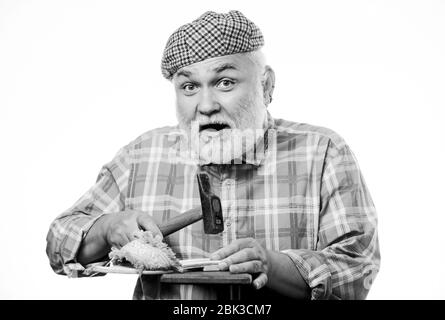 Shoe repair. mature shoemaker in workshop make shoes. shoemaker working with leather textile and hammer at workshop. retro man repair shoes with hammer. Cobbler workmanship. shoemaker at work. Stock Photo