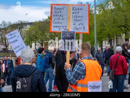 Schwerin Germany 01st May A Piano Player In A Protective Suit Plays At The Vigil To Which Several Hundred Citizens Have Gathered At Pfaffenteich Protesting Against The Corona Protection Measures The