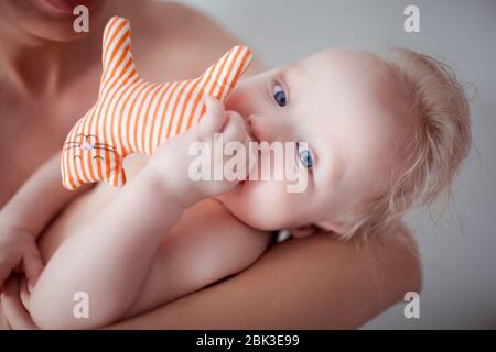 Father with his young baby cuddling and kissing him on cheek. Parenthood, love. Stock Photo