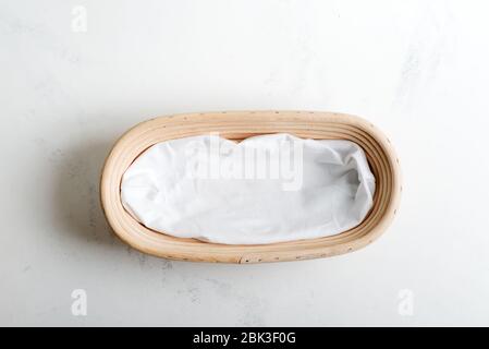 Natural handmade wicker basket for products, homemade pastry or fresh vegetables on a light grey background, copy space. Top view. Stock Photo