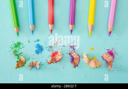 Colouring pencils with sharpenings on blue Stock Photo