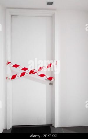 The entrance to the apartment is blocked by a protective tape. Crime scene. Do not enter. Stock Photo