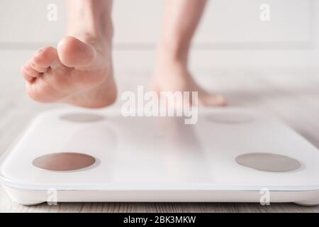 Female foot takes a step on smart scales that makes bioelectric impedance  analysis, BIA, measurements of body fat Stock Photo - Alamy