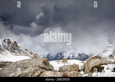 High mountains with snow at overcast dark sky in Tian Shan, Kazakhstan Stock Photo