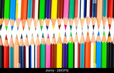 closeup of some pencil crayons of different colors in an ice cream cone on  a pink background Stock Photo - Alamy