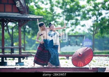 Thailand music, dancing women and man in national style dress costume : thailand dance Stock Photo