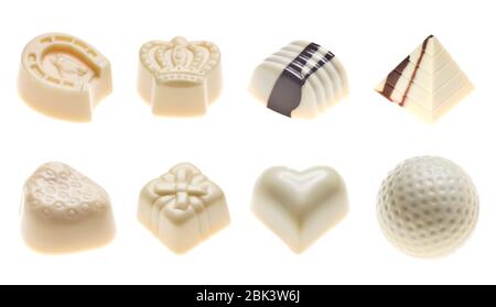 Luxury white chocolate truffles. Assorted delicious handmade pralines in a row isolated on white. Studio shot. Close-up. Stock Photo