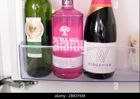 Bottles of wine gin and Ridgeview English Sparkling wine in a cold fridge