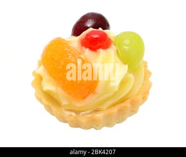 Closeup of cupcake with vanilla cream, pieces of fruits and gelatine topping. Isolated on white background. Stock Photo