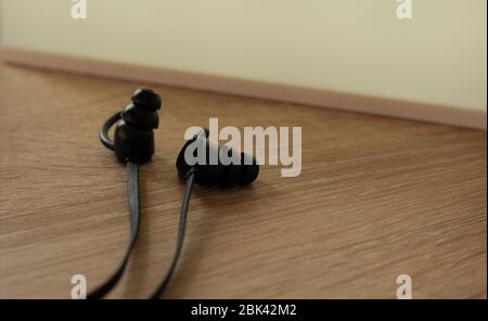 close up wireless headphones on desk with bright sign Stock Photo