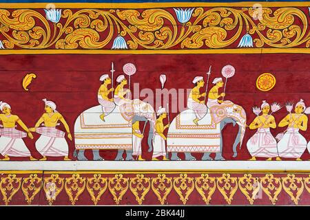 Colourful paintings on the wall at Sacred Tooth Relic Temple in Kandy, Sri Lanka, depicting dancers  and elephants. Stock Photo