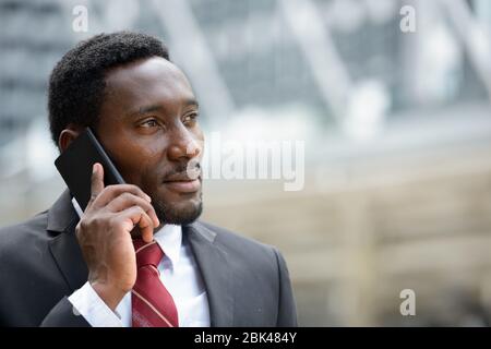 Young handsome African businessman talking on mobile phone Stock Photo