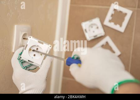 Electrician builder install working switches and sockets black color loft style Stock Photo