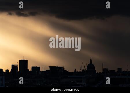 London, UK. 1st May, 2020. UK Weather: Dramatic evening sun rays over the city with St. Paul's Cathedral in view. Credit: Guy Corbishley/Alamy Live News Stock Photo