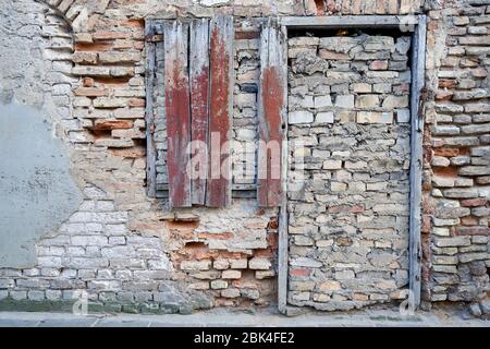 Old brick wall with door bricked up so nobody could enter Stock Photo