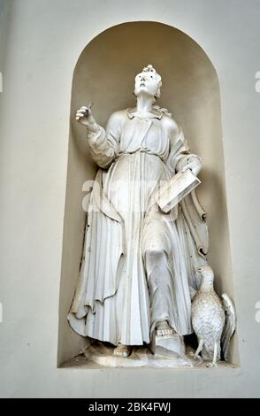 Dusty statue of virgin Mary near the entrance to the church Stock Photo