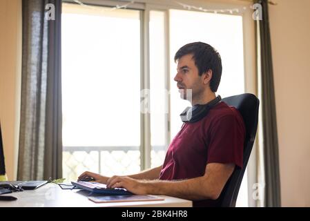 Man working from home in an improvised office in the living room Stock Photo